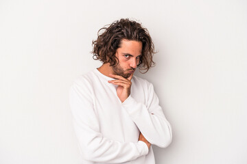 Young caucasian man isolated on gray background contemplating, planning a strategy, thinking about the way of a business.