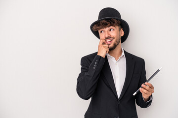 Young arab wizard man holding a wand isolated on white background relaxed thinking about something...