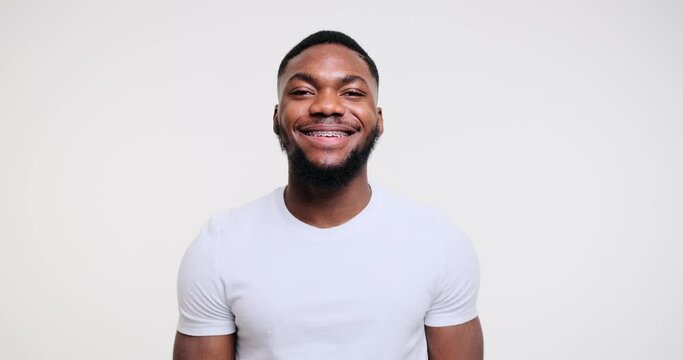 Happy African American man smiling over white background