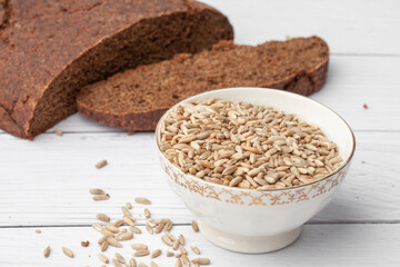 Sliced ​​rye bread on a cutting board. Whole grain rye bread with seeds
