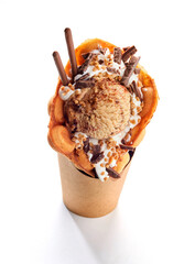 Bubble waffle ice cream with chocolate candies and sticks isolated on a white background