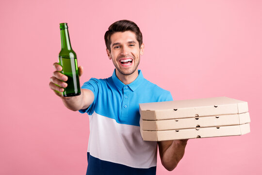 Photo of funky brunet millennial guy hold pizza beer wear striped t-shirt isolated on pink color background