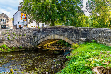 A view of the bridge over Clapham Beck, Clapham at the foot of Ingleborough, Yorkshire, UK in summertime
