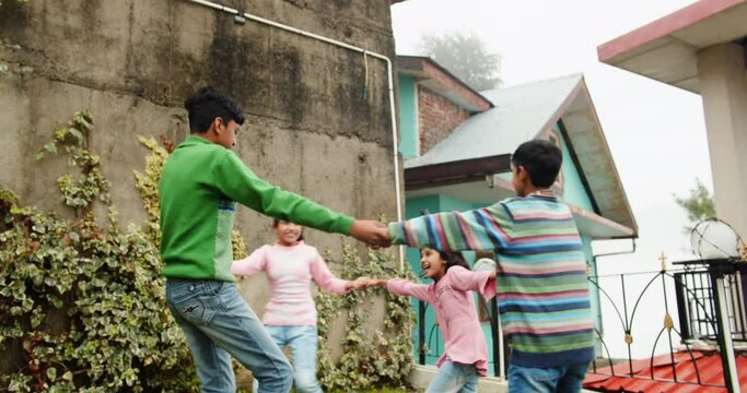 A 4K of South Asian siblings playing in the yard. Shimla, Himachal Pradesh, India