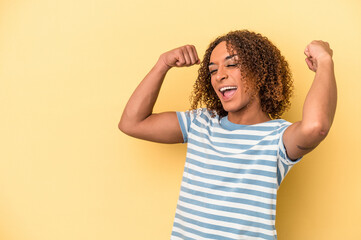 Young latin transsexual woman isolated on yellow background raising fist after a victory, winner concept.