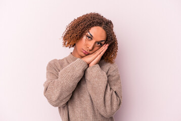 Young latin transsexual woman isolated on pink background yawning showing a tired gesture covering mouth with hand.