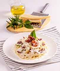 Pasta Carbonara. Spaghetti with bacon, parsel and parmesan cheese. Pasta Carbonara on white plate with parmesan. Italian food.