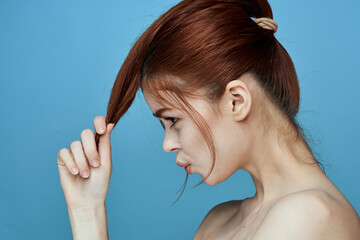 woman with bared shoulders pigtail emotions posing blue background