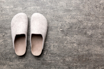 Warm winter women woolen slippers on the floor. Copy space for text