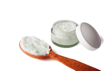 Body scrub with green crystals in wooden spoon. Homemade cosmetic for peeling and spa care. Isolated on white.