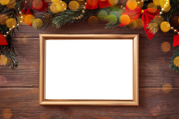 Christmas golden frame with Christmas decorations and bokeh on wooden background, mockup, flat lay, copy space