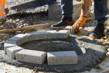 Sewerage construction with utility worker preparation for installing manhole sewage reconstruction