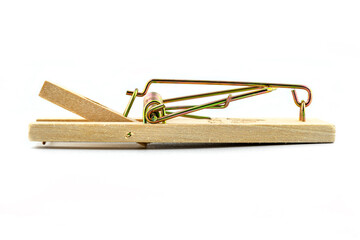 Macro photo of a spring loaded mousetrap, isolated on a white background, side view.