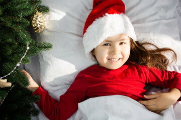 Cute little child girl with xmas present. happy little girl celebrate winter holiday. christmas time. happy new year. delivery christmas gifts. sleeping and relax. Capturing a happy moment.