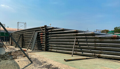 Large steel pipes stacked layers high. For building construction in the outdoor.