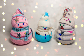 Three handmade snowmen made from improvised materials. Handmade toy snowmen. Handmade Christmas...