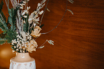 Christmas decor from branches of coniferous trees and dried flowers