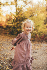 Cute little girl in an autumn forest.