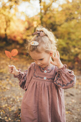 Cute little girl in an autumn forest.