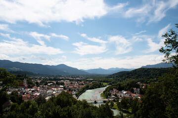 Fototapeta na wymiar View of the town of Bad Tölz in Upper Bavaria in Germany on a summer day, with the Isar river flowing through the town and the mountains of the Alps in the distance