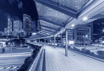 Modern pedestrian walkway in downtown of Hong Kong city at night