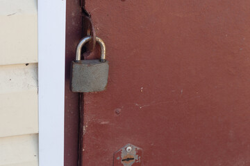 overhang lock hangs on the red iron door