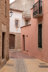 old street in begur with pastel colored houses