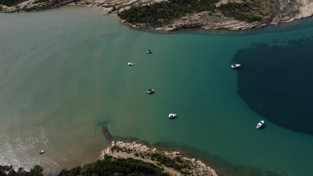 Rab Island, Croatia. Aerial View of Scenic Coastline, Boats in Bay, Capes and Calm Adriatic Sea, Tilt Up Drone Shot