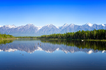 Fototapeta na wymiar Landscape with mountains reflecting in the water on summer day. Buryatia, Tunkinskaya valley