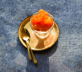 Dried apricot fruit,back lit and isolated on light blue background.Sweet,juicy,rich orange colored...
