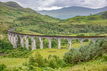 Fototapeta na wymiar The Glenfinnan Viaduct is a railway viaduct on the West Highland Line in Glenfinnan, Inverness-shire, Scotland. Located at the top of Loch Shiel in the West Highlands of Scotland, the viaduct overlook