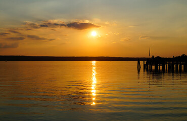 a pier on lake Ammersee at sunset in Herrsching on a warm August night (Bavaria, Germany)