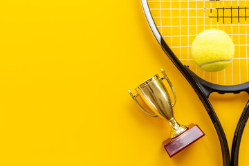 Tennis champion award - small golden trophy cup with tennis racket and ball