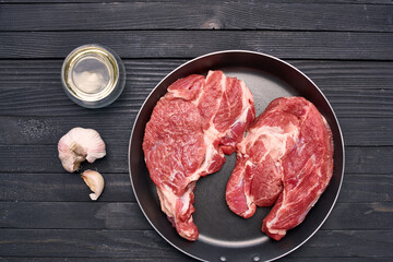 meat steak in a frying pan food ingredients kitchen wooden table