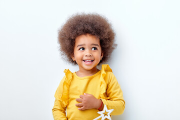 cheerful fluffy african american girl looking happy holding magic wand in hands, laughing, isolated...