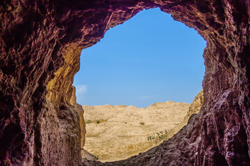 Bright blue sky as it seen from darkness of cave. Exit or entrance or 'window' in underground cell of Buddhist monks on Kara-Tepe hill, Termez, Uzbekistan. Settlement existed in I-V centuries AD