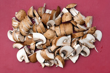 Raw mushrooms chopped on a board top view. Chopped champignons close-up. Cooking mushroom dishes.