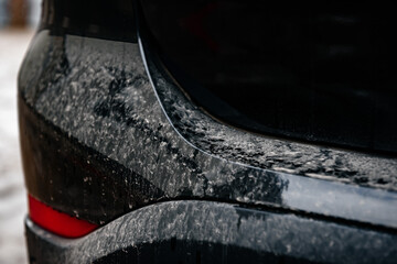 Closeup of black dirty car.