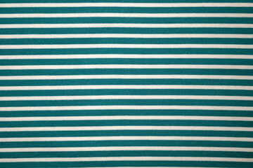 Fabric green cotton striped top view. Cotton and polyester fabric texture. Close-up textiles.