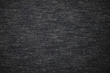 Gray fabric texture top view. Fragment of clothing from cotton background. The fabric is soft, dark gray. Textile grunge background.