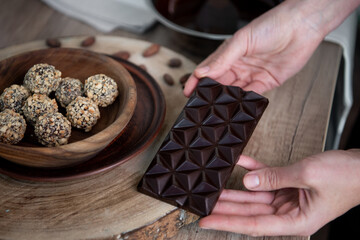 Chocolate in the women's hands. Close-up. Copy space. 
