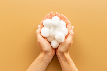 Cotton wool balls in female hands - clean and care for skin