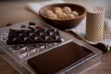 Chocolate on wooden table. Close-up. Copy space. 
