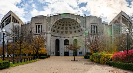 Fotobehang Historic Ohio Stadium with rotunda entrance against a cloudy sky in Columbus USA © James Moore/Wirestock
