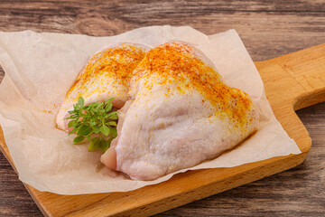 Raw chicken thigh with spices
