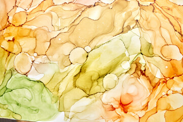 Abstract ocher green watercolor background. Yellow orange brown paint stains and spots in water,...
