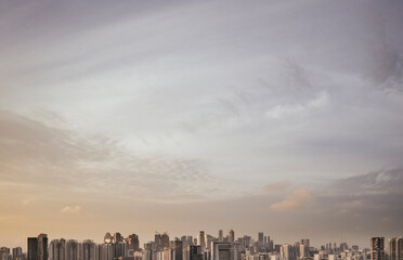 Wispy clouds above Singapore city skyline at sunrise