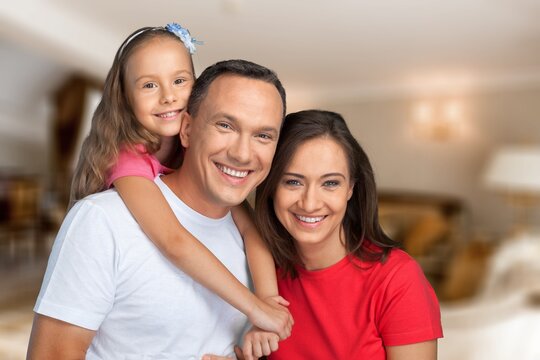 Portraif Of Happy Parents Posing With Their Little children At Home