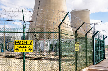 Security fence with danger warning signs of a nuclear power station