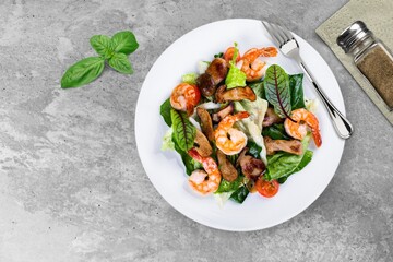Fresh green salad, spinach, tomatoes in white bowl